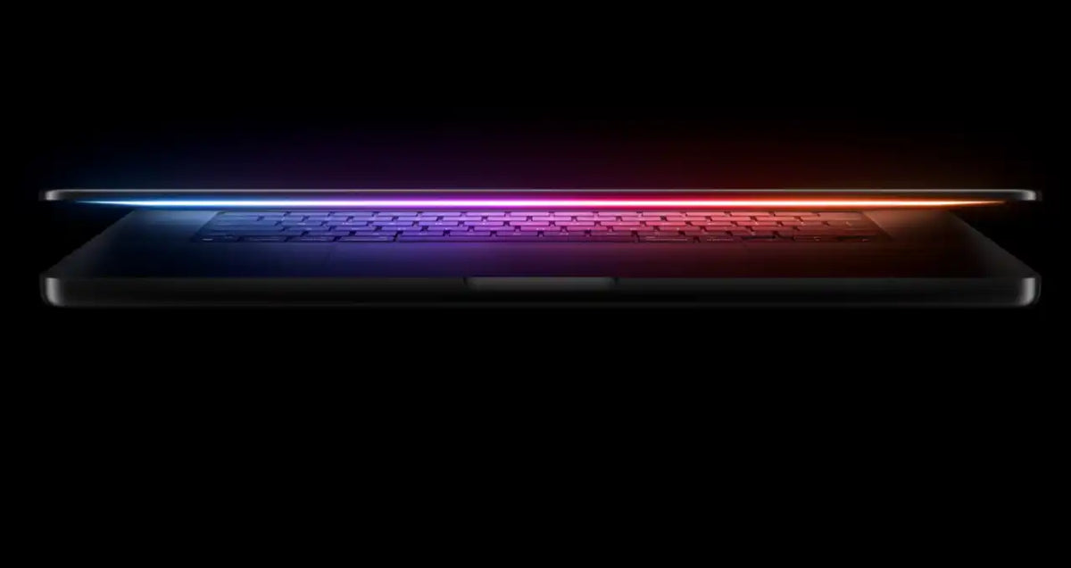 a laptop with a glowing, colorful light on the screen, creating a visually striking and futuristic appearance.