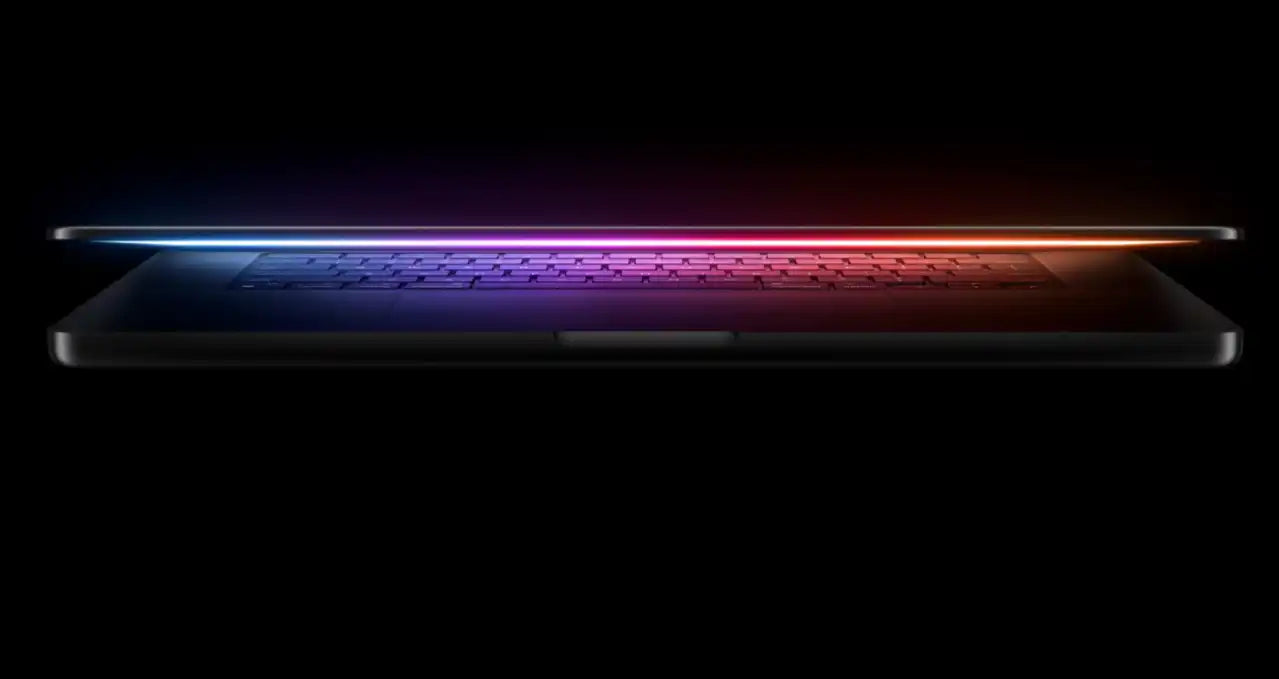 a laptop with a glowing, colorful light on the screen, creating a visually striking and futuristic appearance.