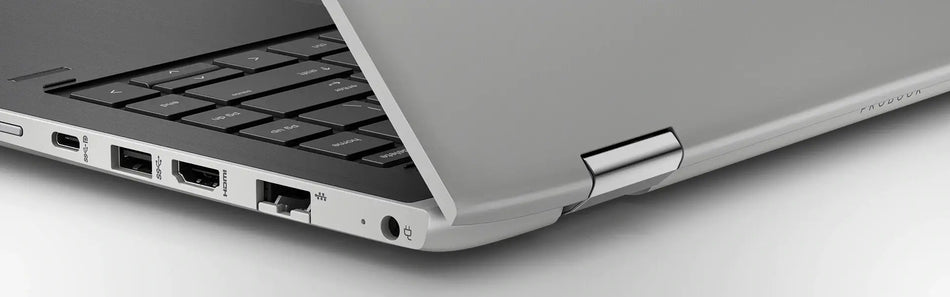 a close-up view of the side of a laptop computer, focusing on the keyboard and the laptop's ports and connections.