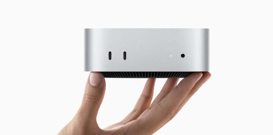 A hand holding a small, silver-colored device, possibly a piece of technology or a small electronic device.