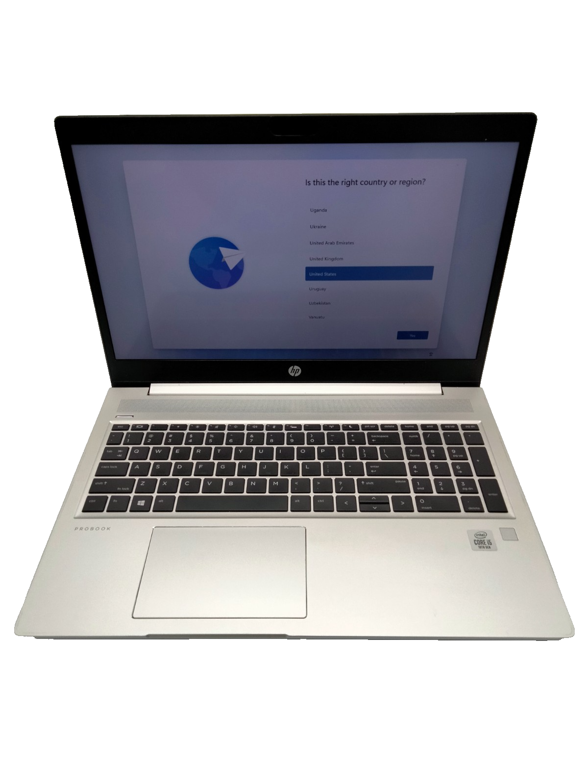 a silver laptop with a black keyboard and trackpad, displaying a screen with a question and answer interface.