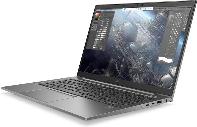 a laptop with a large screen displaying a cityscape wallpaper.