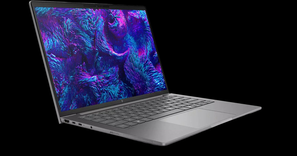 a silver laptop with a vibrant, abstract wallpaper on its screen.