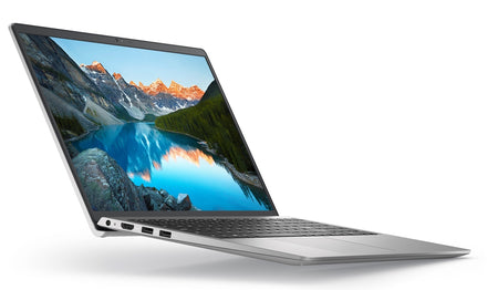 a laptop with a large, high-resolution wallpaper of a scenic mountain landscape on its screen.