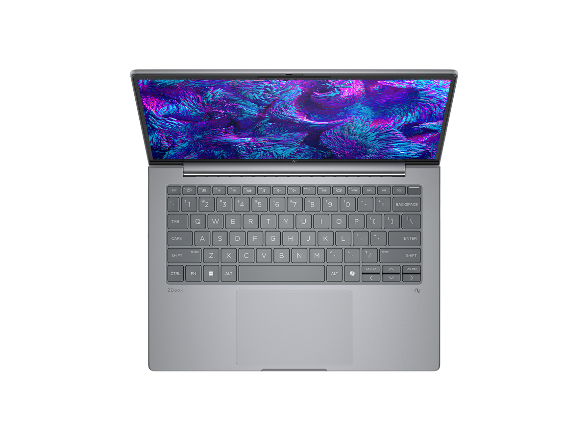 a silver laptop with a vibrant, colorful wallpaper displayed on its screen.