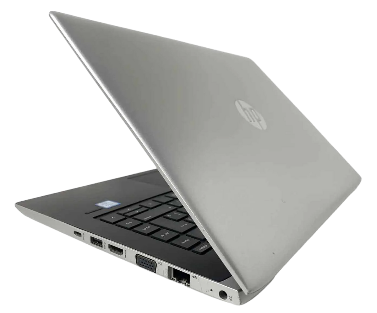 a silver HP laptop with its lid open, revealing the keyboard and other ports.