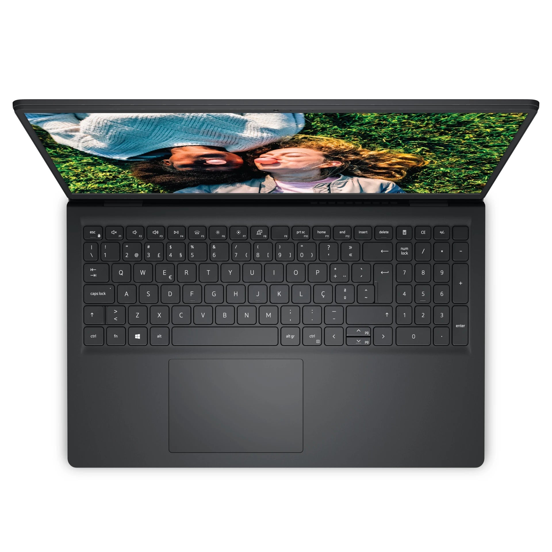 an open laptop with a black keyboard and a screen displaying a photo of two people lying on the grass.