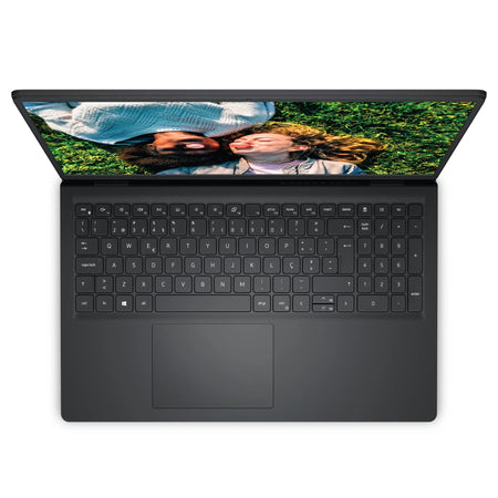 an open laptop with a black keyboard and a screen displaying a photo of two people lying on the grass.
