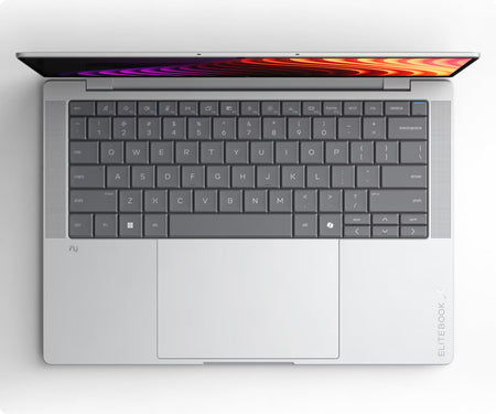 an open laptop computer with a silver keyboard and a colorful, abstract wallpaper on the screen.