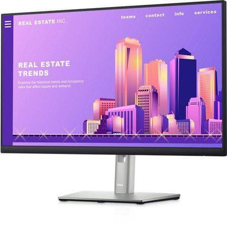 Dell monitor displaying a colorful real estate trends website with a city skyline backdrop.