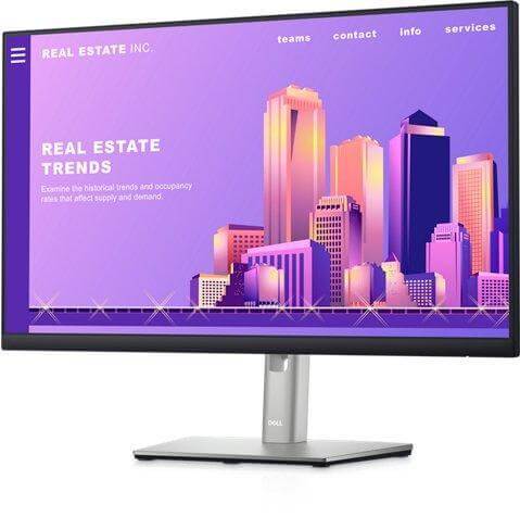 Dell monitor displaying a colorful real estate trends website with a city skyline backdrop.